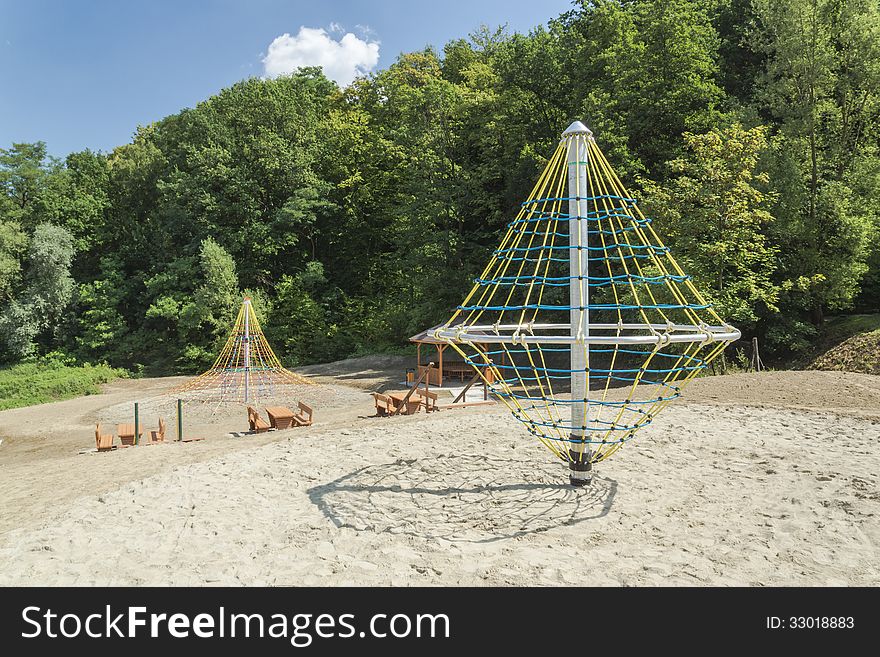 A colourful children playground equipment. In park in the little city.