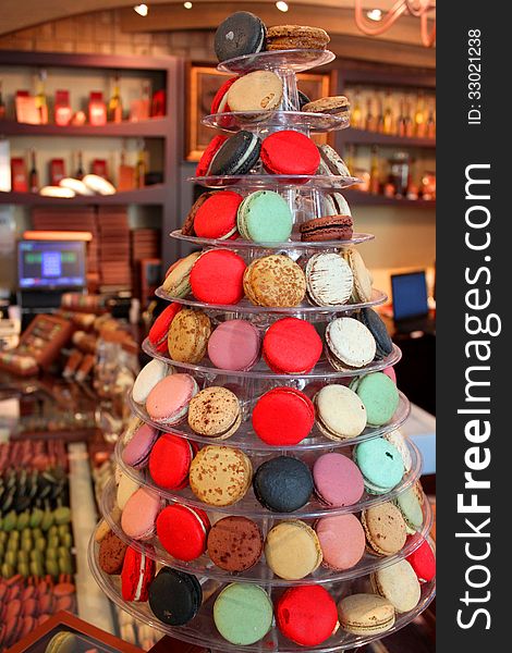 Fir-shaped arrangement made ​​delicious cookies and colored macaroons in market. Fir-shaped arrangement made ​​delicious cookies and colored macaroons in market.