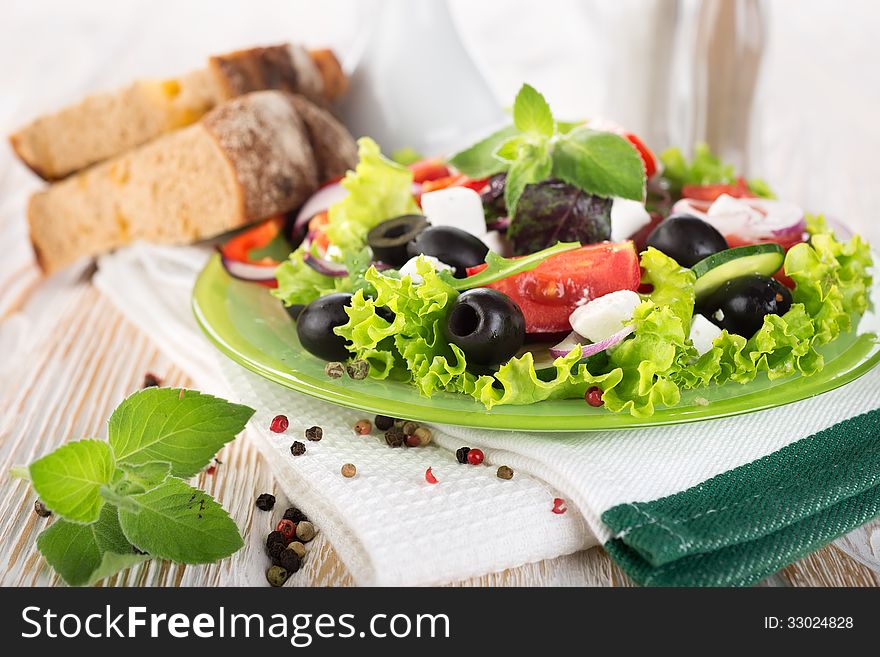 Colorful vegetable salad on a wooden background