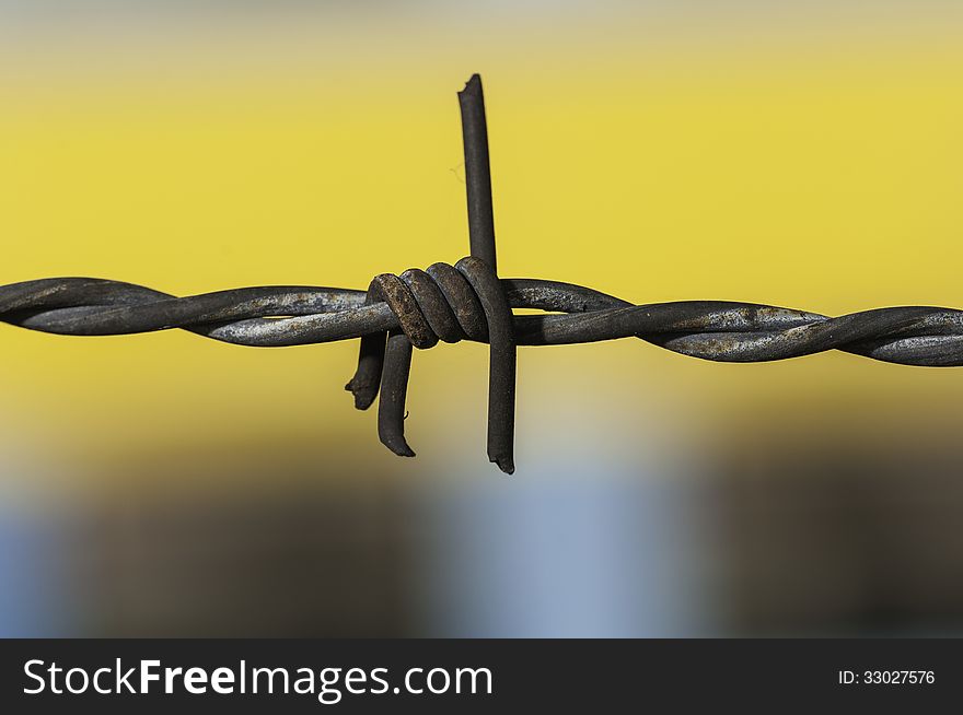 Barbed wire kink close up blurry background. Barbed wire kink close up blurry background