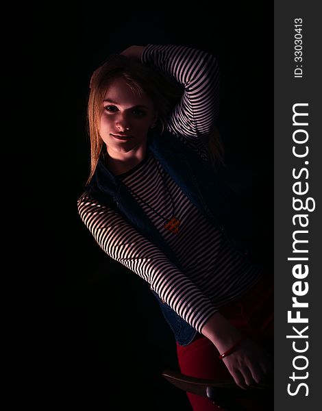 Portrait of beautiful thoughtful girl close up in the dark