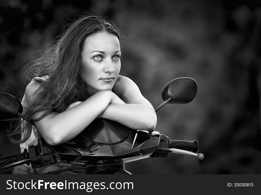 Beautiful woman thinking on a motorcycle. Beautiful woman thinking on a motorcycle