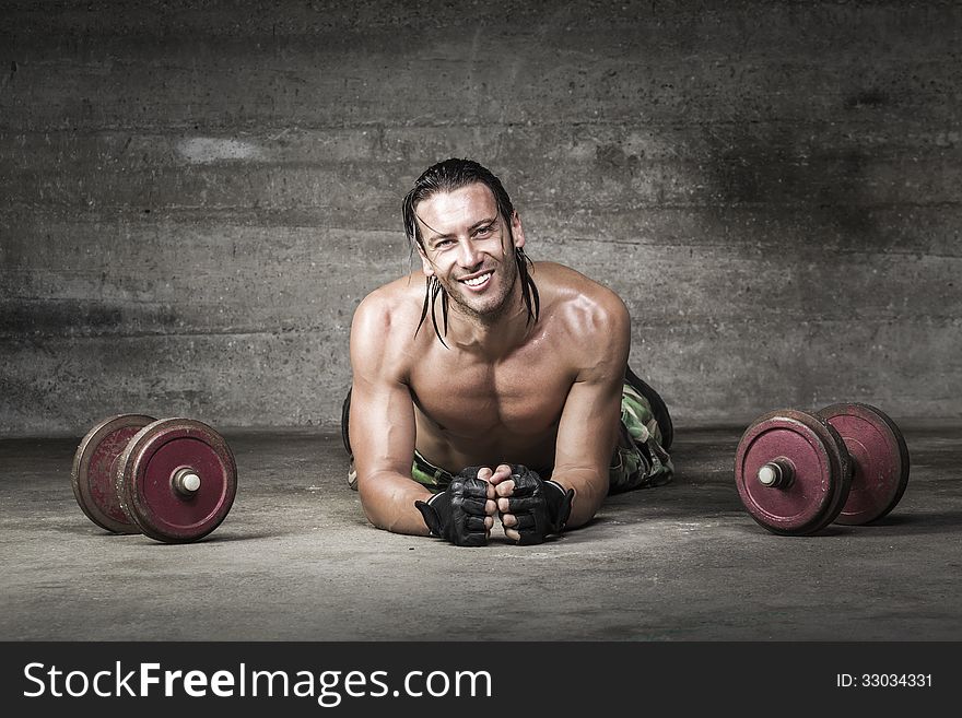 Portrait Of Muscle And Smiling Athlete