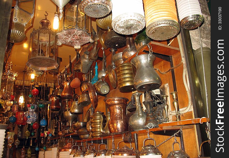 Antique eastern cooking utensils in a junk shop. Antique eastern cooking utensils in a junk shop