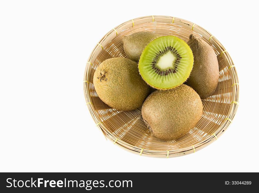 Whole kiwi fruit and his sliced segments isolated in basket, on white background cutout. Whole kiwi fruit and his sliced segments isolated in basket, on white background cutout