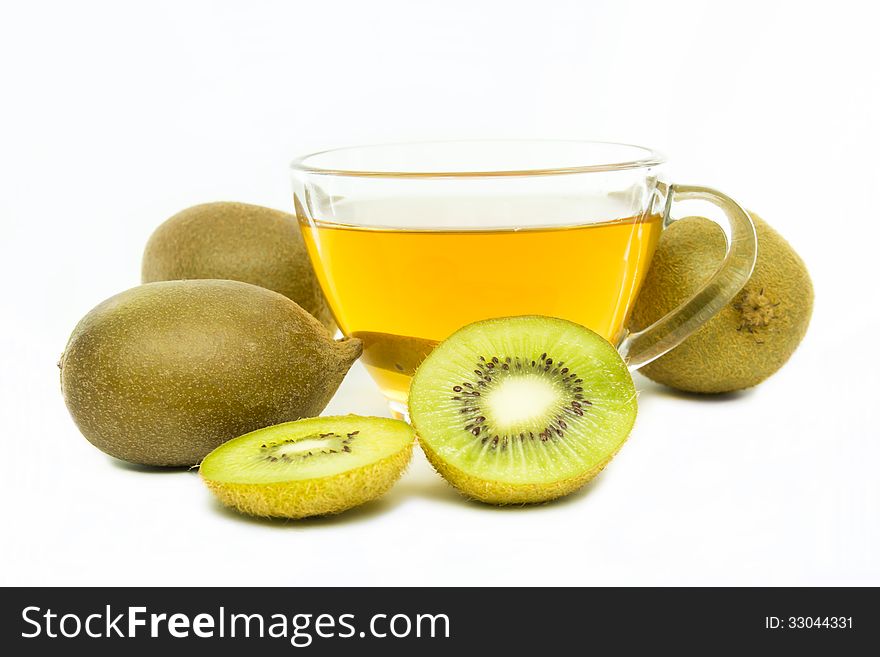 Tea in cup and piece of kiwi fruit isolated on white background. Tea in cup and piece of kiwi fruit isolated on white background