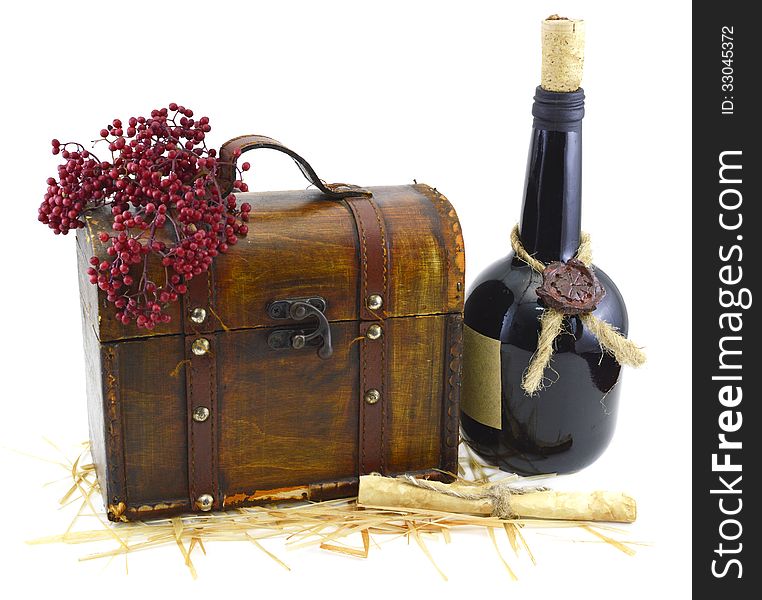 Old wooden box with bunch of red berries and bottle of wine isolated. Old wooden box with bunch of red berries and bottle of wine isolated