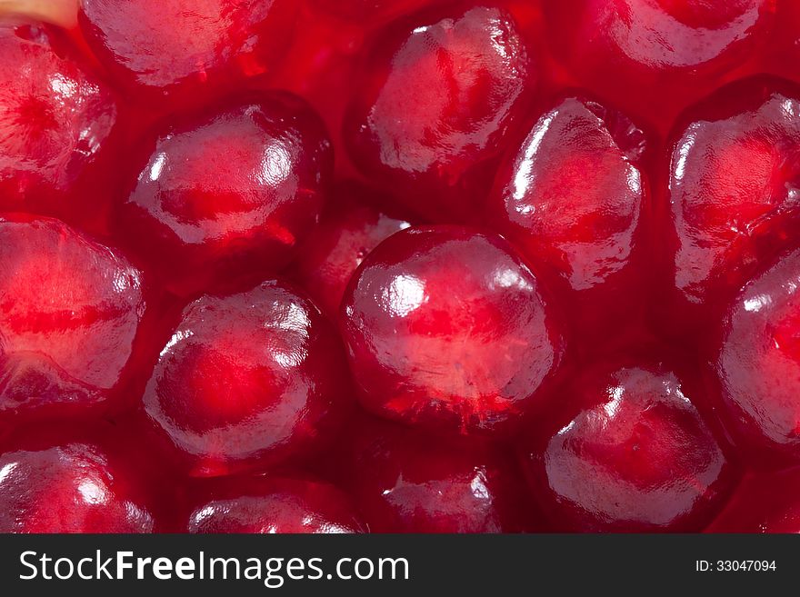 Juicy red pomegranate seeds - macro texture