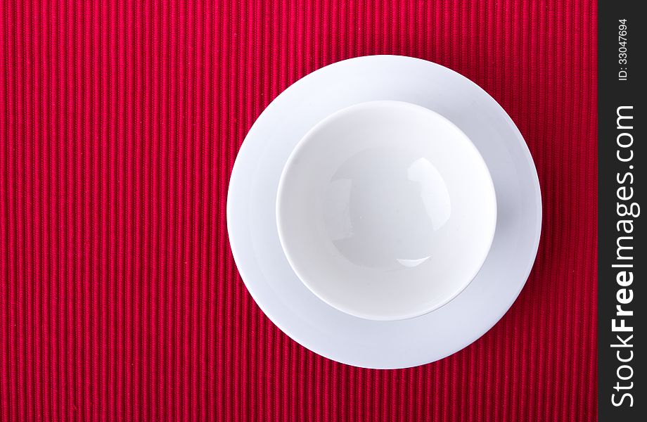 Empty bowl isolated on red background