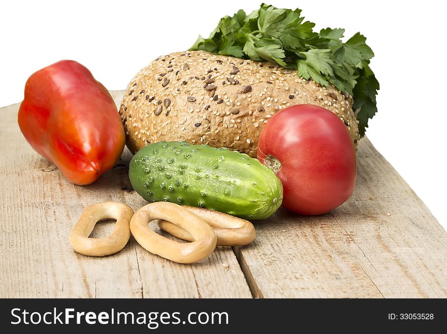 Bread tomato pepper drying bagels seeds sesame salad parsley green buffet wooden board grass beige red yellow orange agriculture isolated white background. Bread tomato pepper drying bagels seeds sesame salad parsley green buffet wooden board grass beige red yellow orange agriculture isolated white background
