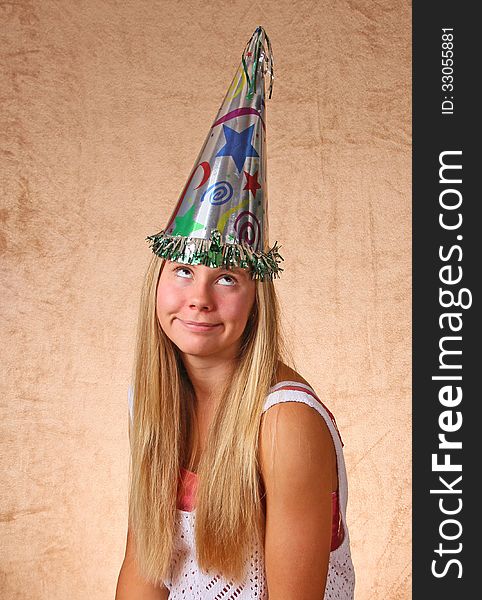 Young Teen With Silly Expression Wearing Celebration Cap. Young Teen With Silly Expression Wearing Celebration Cap
