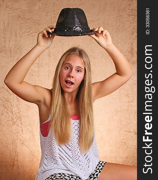 Teenage Female Holding Black Hat. Teenage Female Holding Black Hat