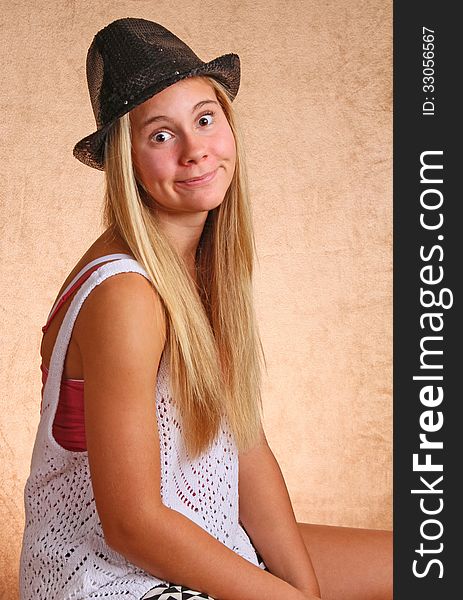 Teenage Female With Black Hat And Silly Expression. Teenage Female With Black Hat And Silly Expression