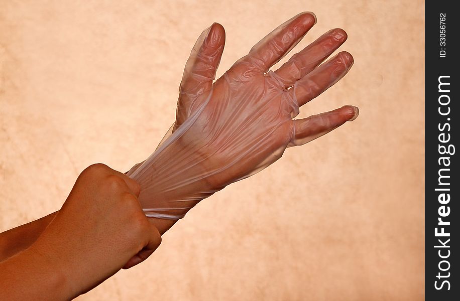 Woman's Hand Pulling On Rubber Glove. Woman's Hand Pulling On Rubber Glove