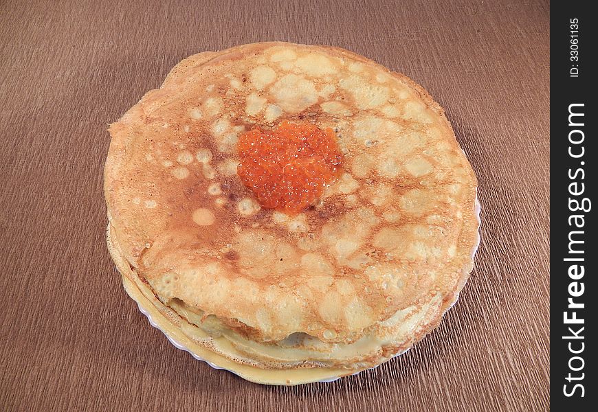 Pancakes with red caviar on a plate