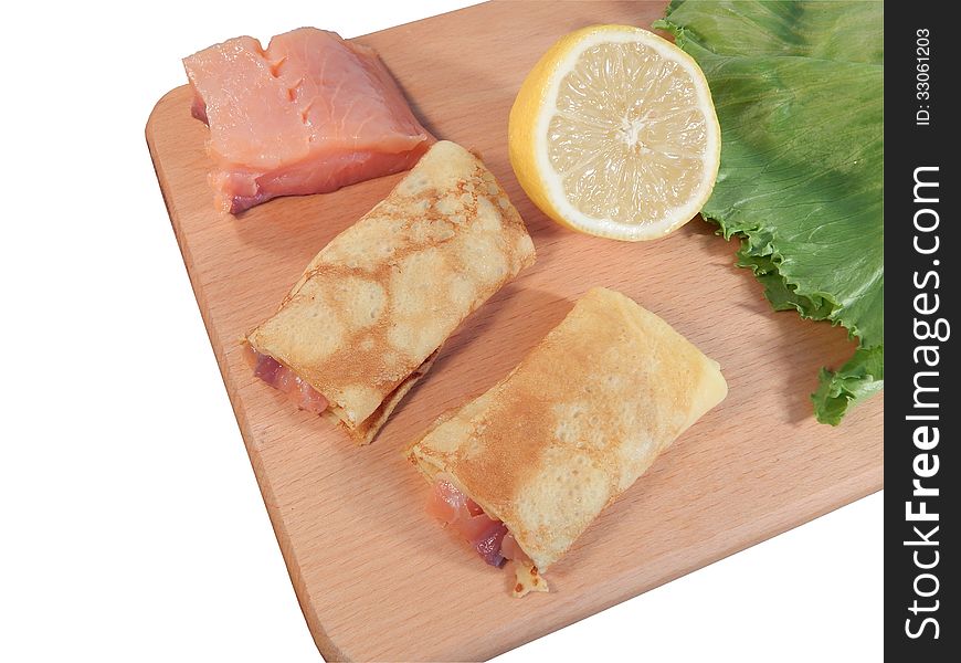 Pancakes with red fish salmon on wooden stand