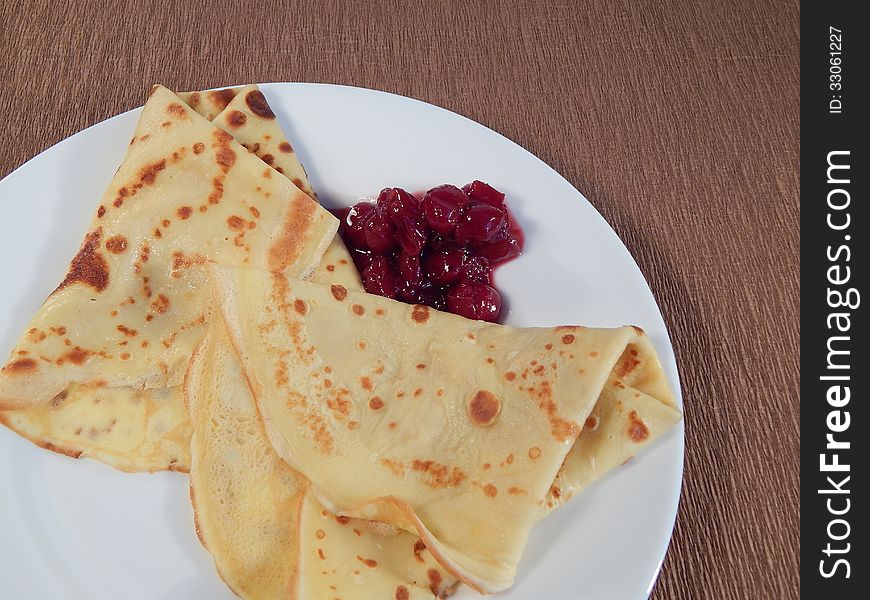 Pancakes with cherry jam on a plate
