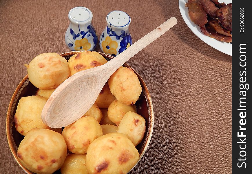 Baked potatoes in a clay pot and roast pork