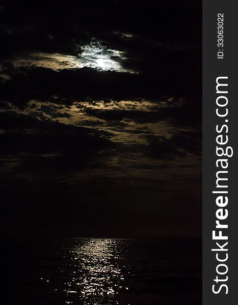 Moon covered by clouds at the black sea. Moon covered by clouds at the black sea