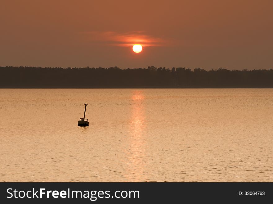 Buoy on the lake in sunset. Buoy on the lake in sunset