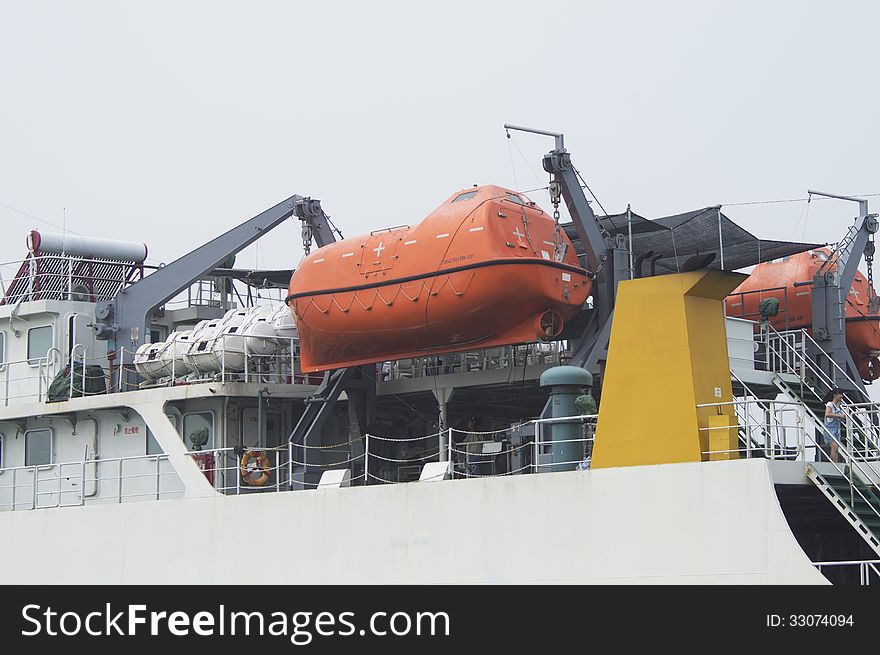 Lifeboat on a davit at a modern ferry ship. Lifeboat on a davit at a modern ferry ship