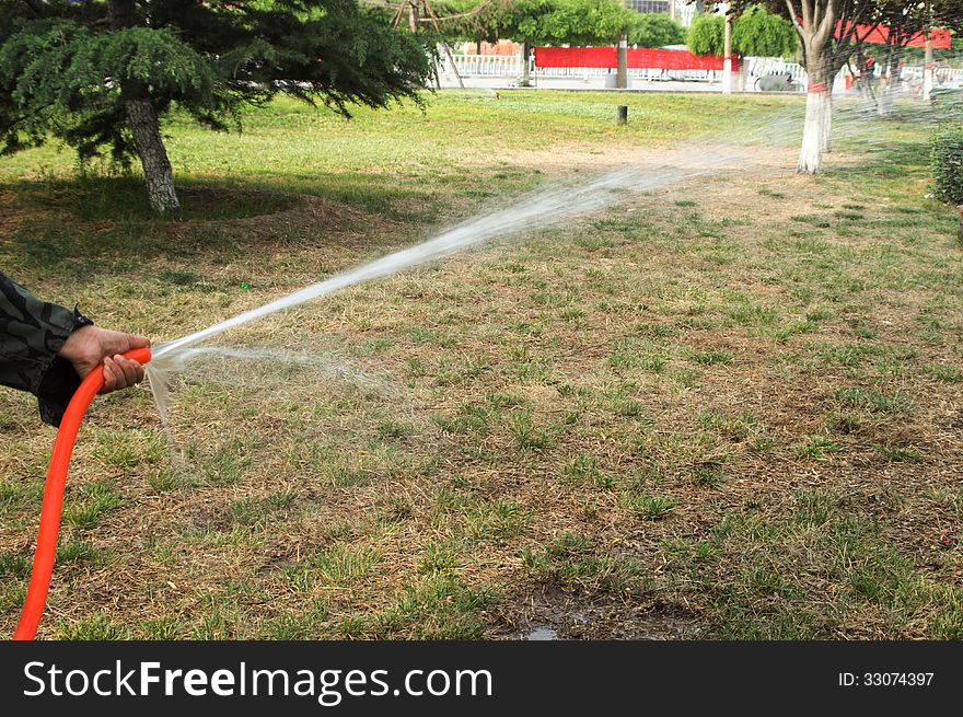 The water sprinkler in garden. The water sprinkler in garden