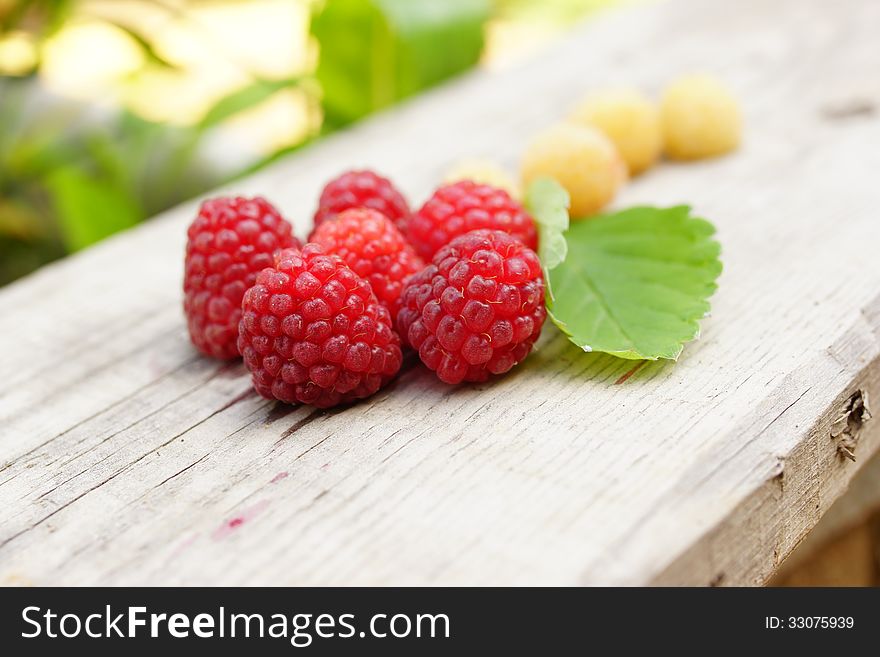 Still-life from white and red raspberries in the form of a flower with a leaf strawberry. Still-life from white and red raspberries in the form of a flower with a leaf strawberry.