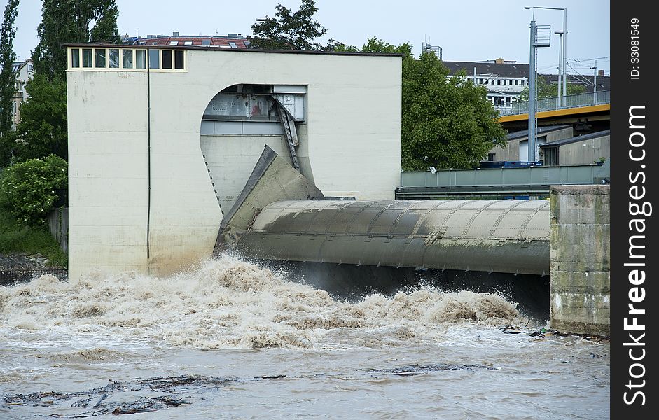Raging brown water at a water lock in the river Neckar at high water. Raging brown water at a water lock in the river Neckar at high water