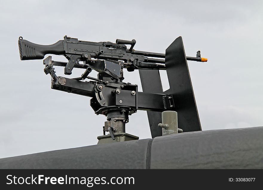 A Machine Gun Mounted on the Top of a Military Vehicle. A Machine Gun Mounted on the Top of a Military Vehicle.