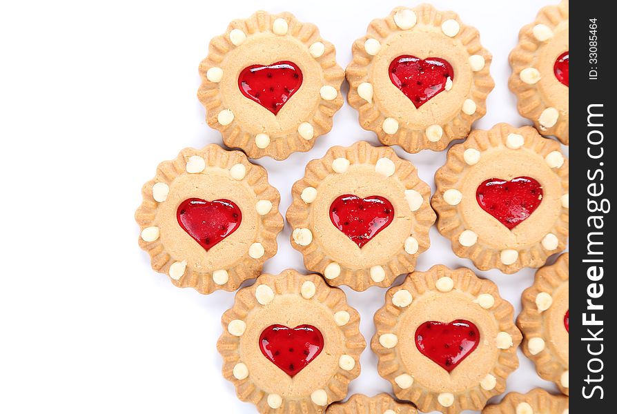 Heart shaped strawberry biscuit on a white background. Heart shaped strawberry biscuit on a white background.