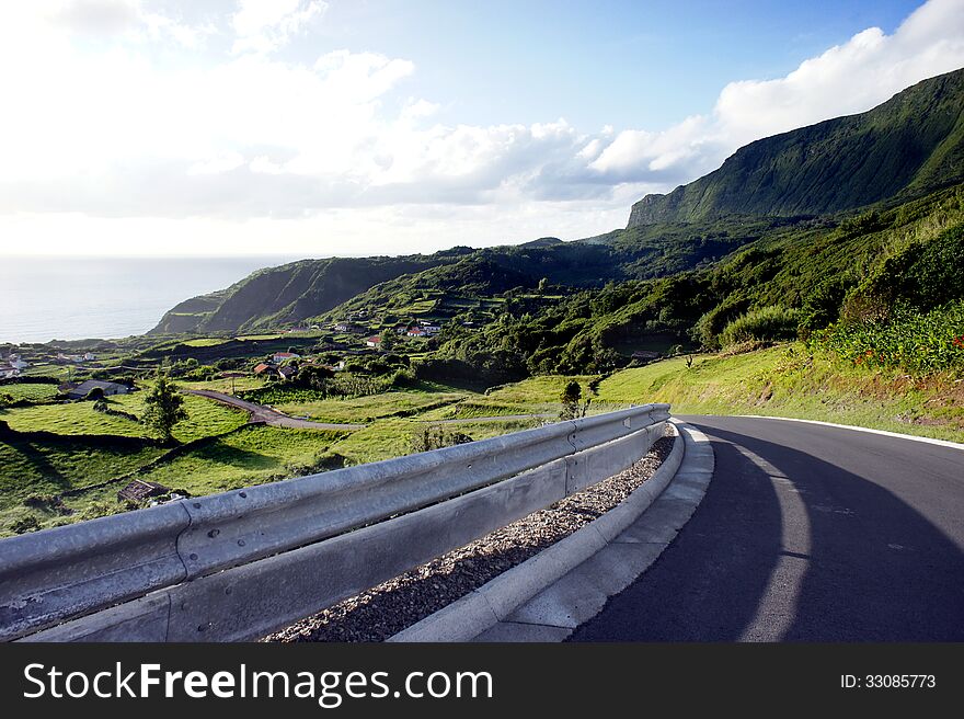 A shot of a peaceful road in the Flores island, in the Azores archipelago. A peaceful place in the middle of Atlantic Ocean. A shot of a peaceful road in the Flores island, in the Azores archipelago. A peaceful place in the middle of Atlantic Ocean.