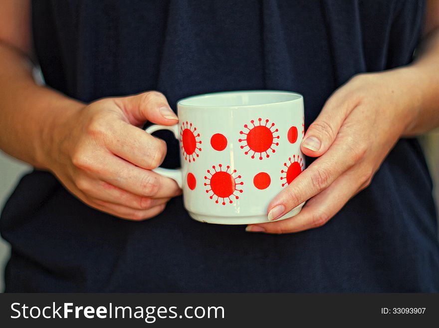 Hands of a woman holding a cup. Hands of a woman holding a cup