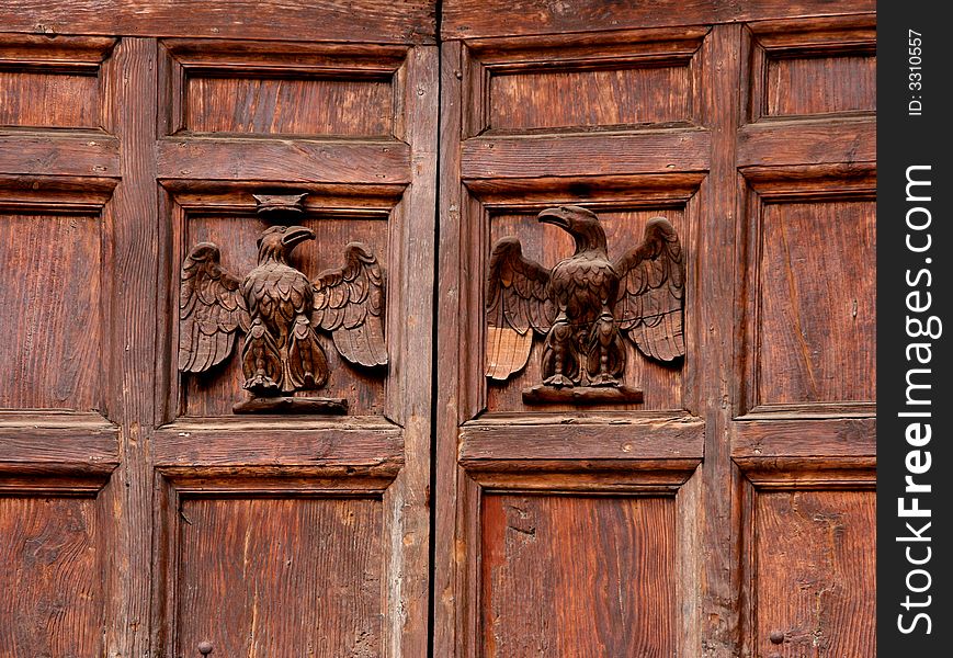 Two eagles carved in wood on an old door. Two eagles carved in wood on an old door