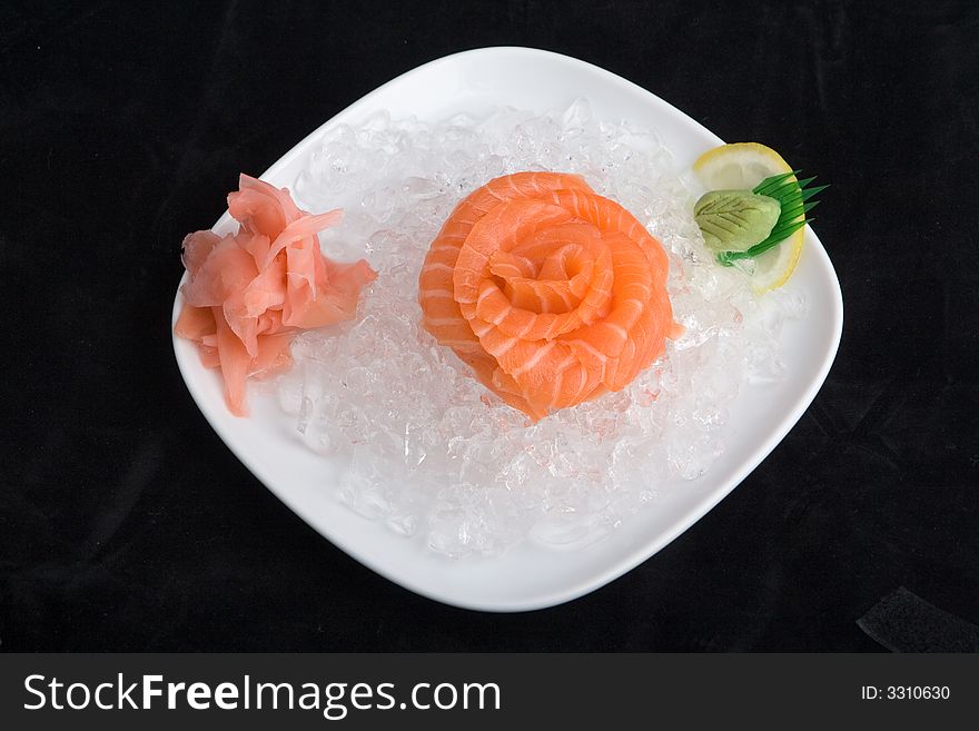 Sashimi in ice (isolated in black)