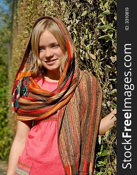 Beautiful girl in a scarf in the park