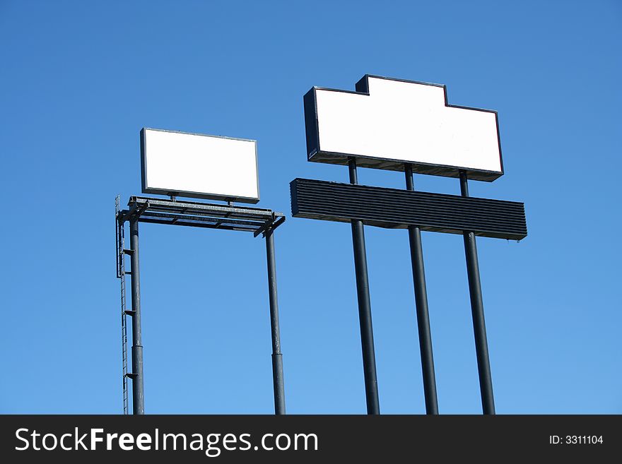 Two Blank Signs against blue sky