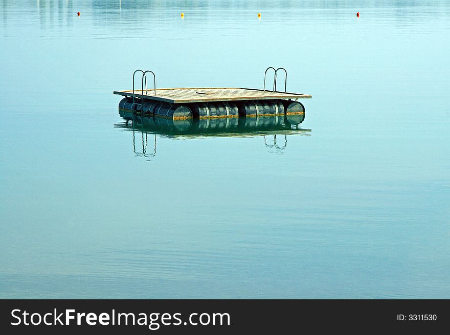 Deck for swimmers floating on a calm lake. Deck for swimmers floating on a calm lake