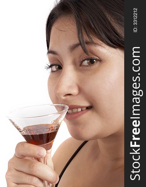 A young woman drinking a cocktail beverage over a white background. A young woman drinking a cocktail beverage over a white background