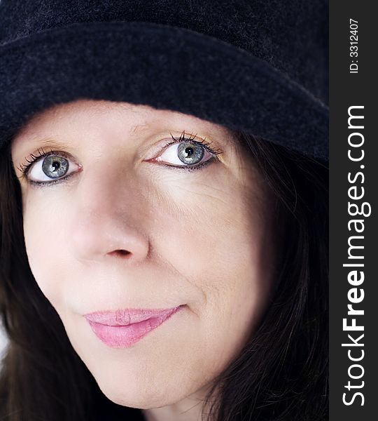 Middle-age woman portrait with black hat on, face close-up. Middle-age woman portrait with black hat on, face close-up