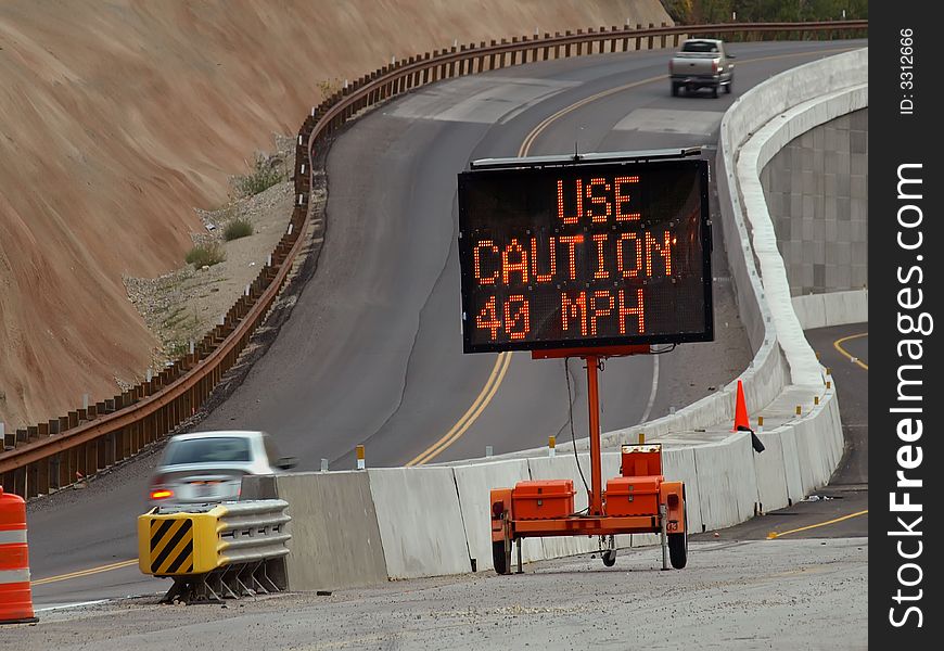 New road construction and detour with portable warning sign. New road construction and detour with portable warning sign