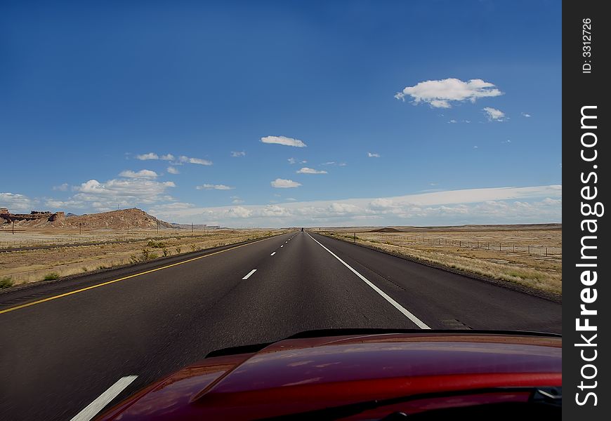 Driving down highway in rural desert setting. Driving down highway in rural desert setting