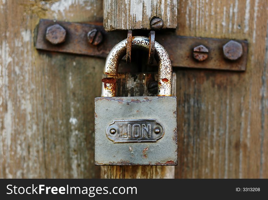 Rusty padlock on old door