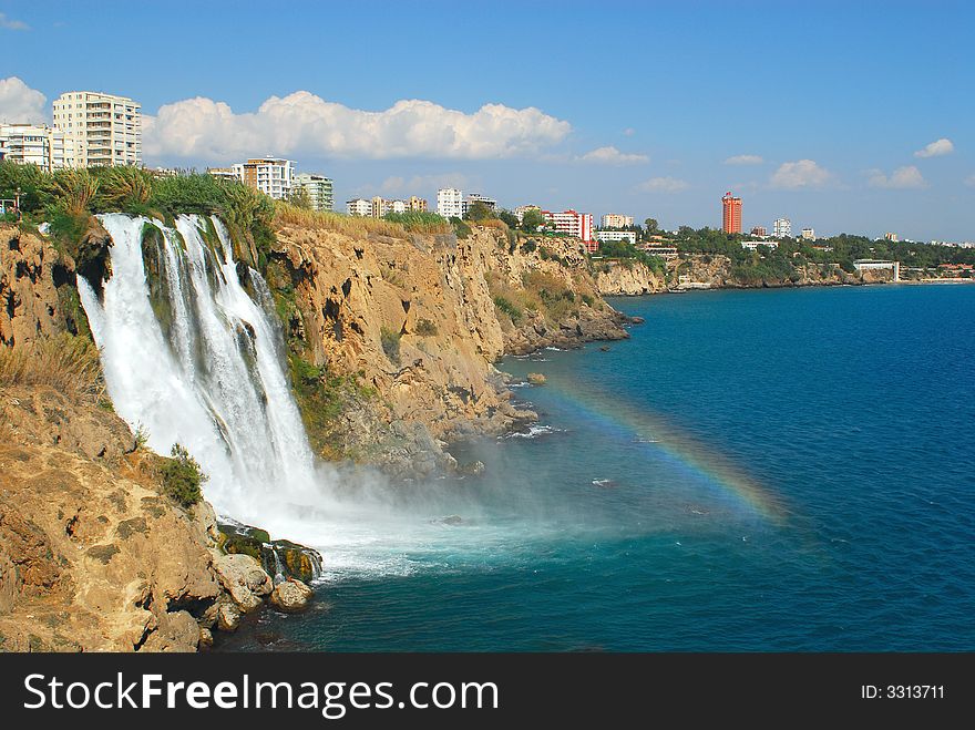 Falls of the river in sea on a background city
