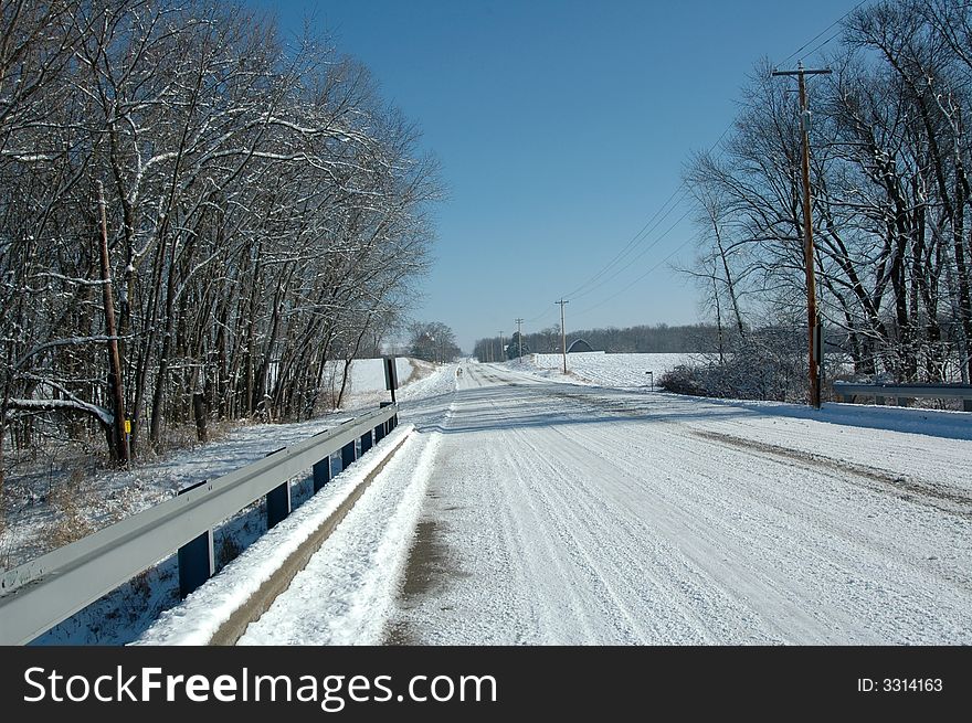 Snowy winter road with blue sky