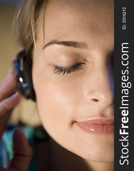A young woman listening to music on her headphones. A young woman listening to music on her headphones