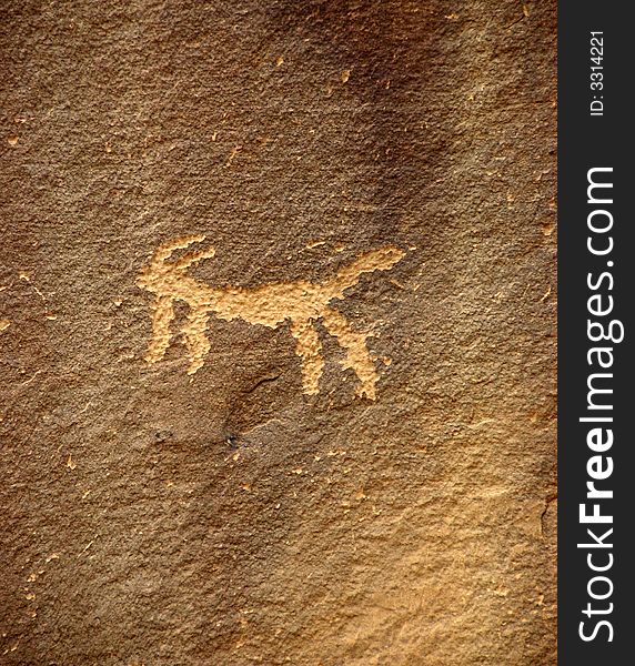 Ancient Anasazi petroglyphs etched into a rock wall