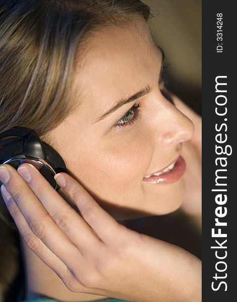 A young woman listening to music on her headphones. A young woman listening to music on her headphones