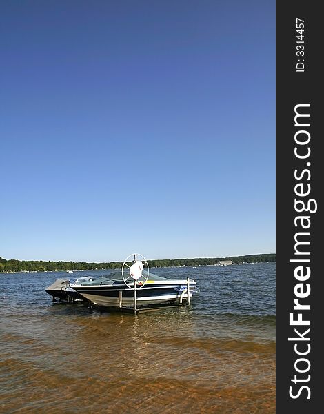 Motor boats anchored by the lake shore. Motor boats anchored by the lake shore