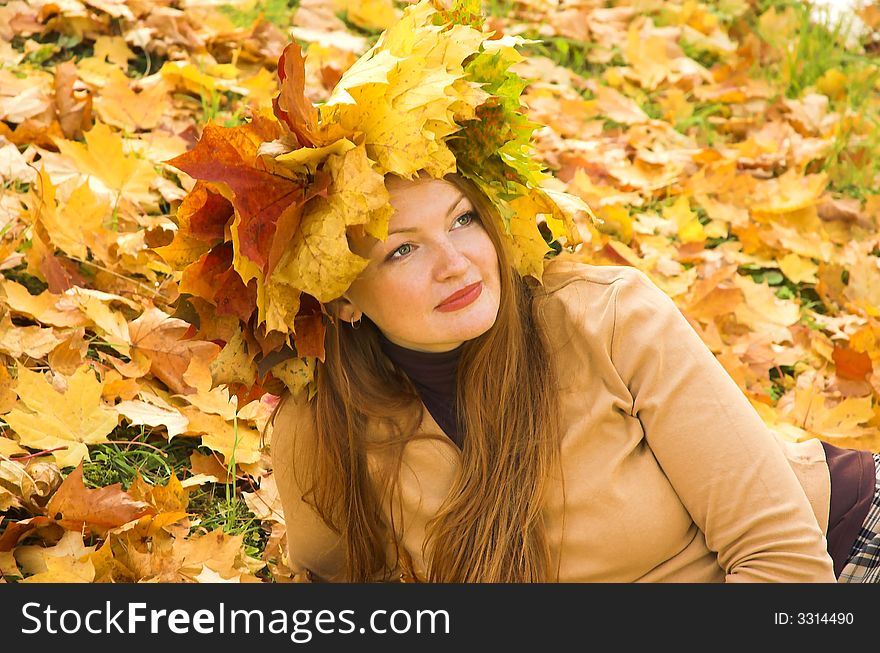 Portrait of the girl in a wreath from maple leaves