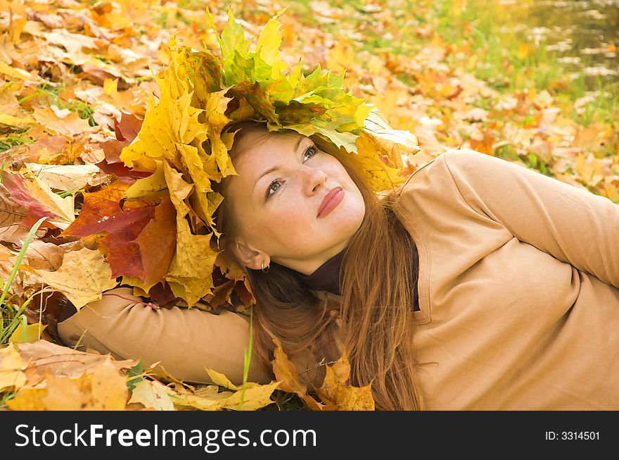 Portrait of the girl in a wreath from maple leaves